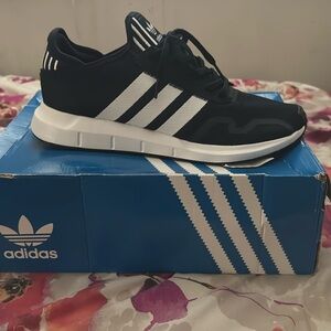 Navy blue and white Adidas sneakers